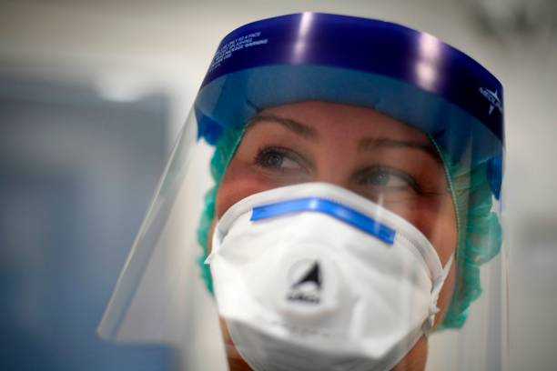Nurse wearing mask and faceshield. 